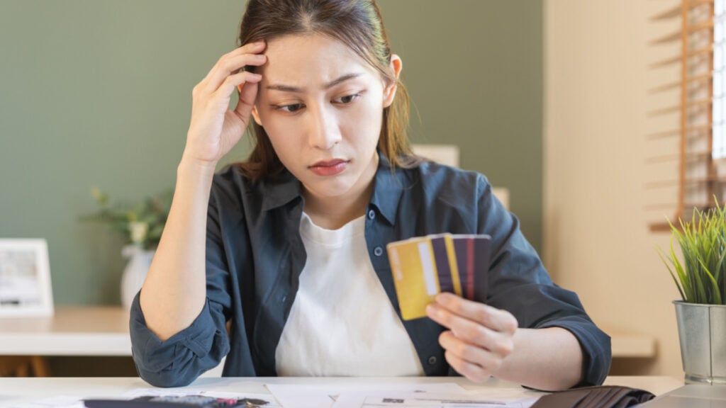 Woman sitting down comparing credit cards