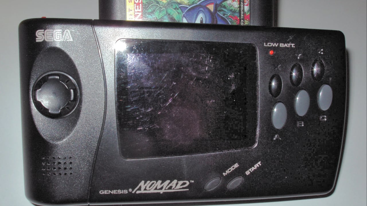 A Sega Genesis Nomad with a Sonic the Hedgehog 3 (Mega Hit Series edition) cartridge inserted