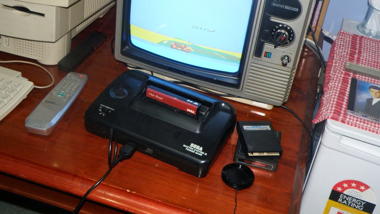 A Sega Master System 2, a old Rank-Arena television set, and a two old video-game cartridges for other systems.