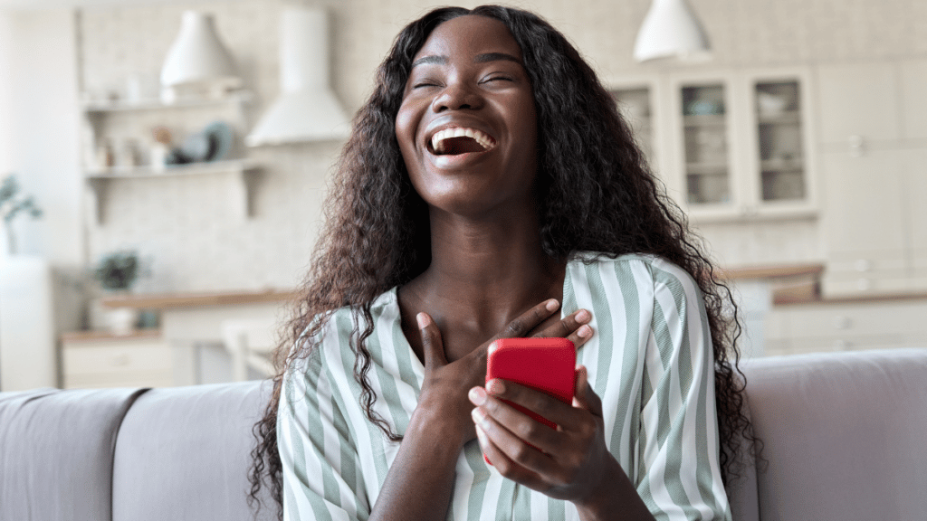 Smiling woman playing games on her mobile phone